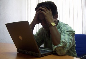 Frustrated man at a laptop
